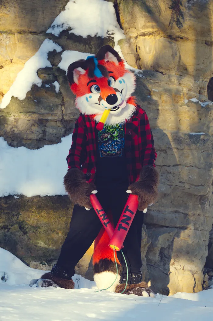 Photo of Vulpy holding cartoon TNT in snow